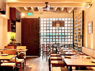 Intimate dining seating arrangement within contemporary Burmese restaurant interior