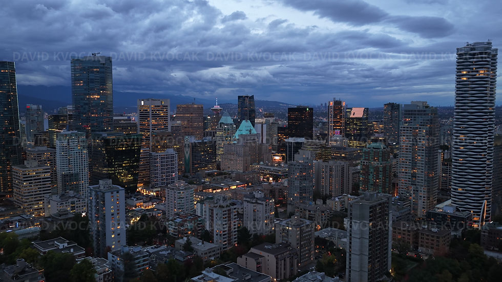Downtown Vancouver towers under storm clouds, aerial drone footage