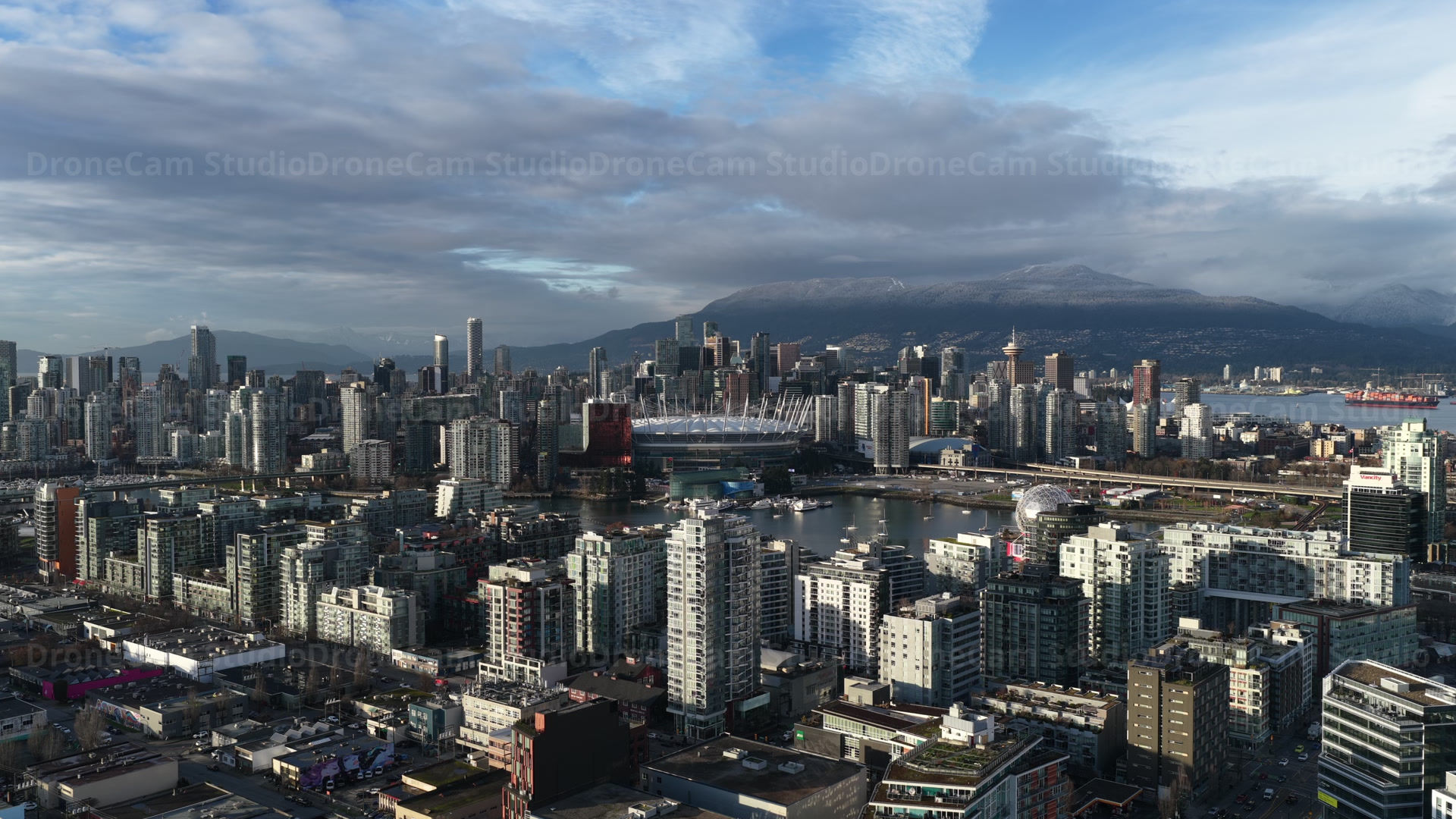 Downtown Vancouver under dramatic clouds, aerial drone footage