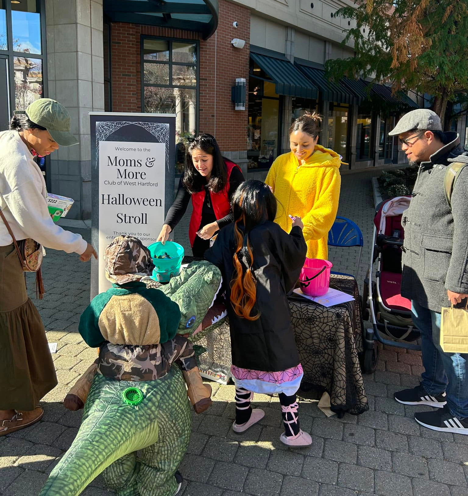 The Moms & More booth gives out candy to costumed trick-or-treaters.
