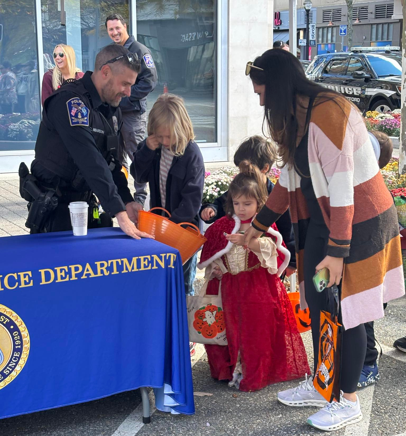A West Hartford Police Officer hands out candy.