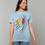 Thumbnail: A person wearing a T-shirt with an abstract design of three faces