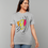 Thumbnail: A person wearing a T-shirt with an abstract design of three faces