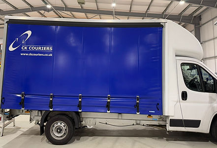 Luton curtainside courier van.