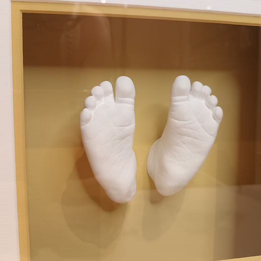 stone baby feet cast close up in a frame