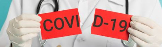 medico con cartello con scritocovid 19