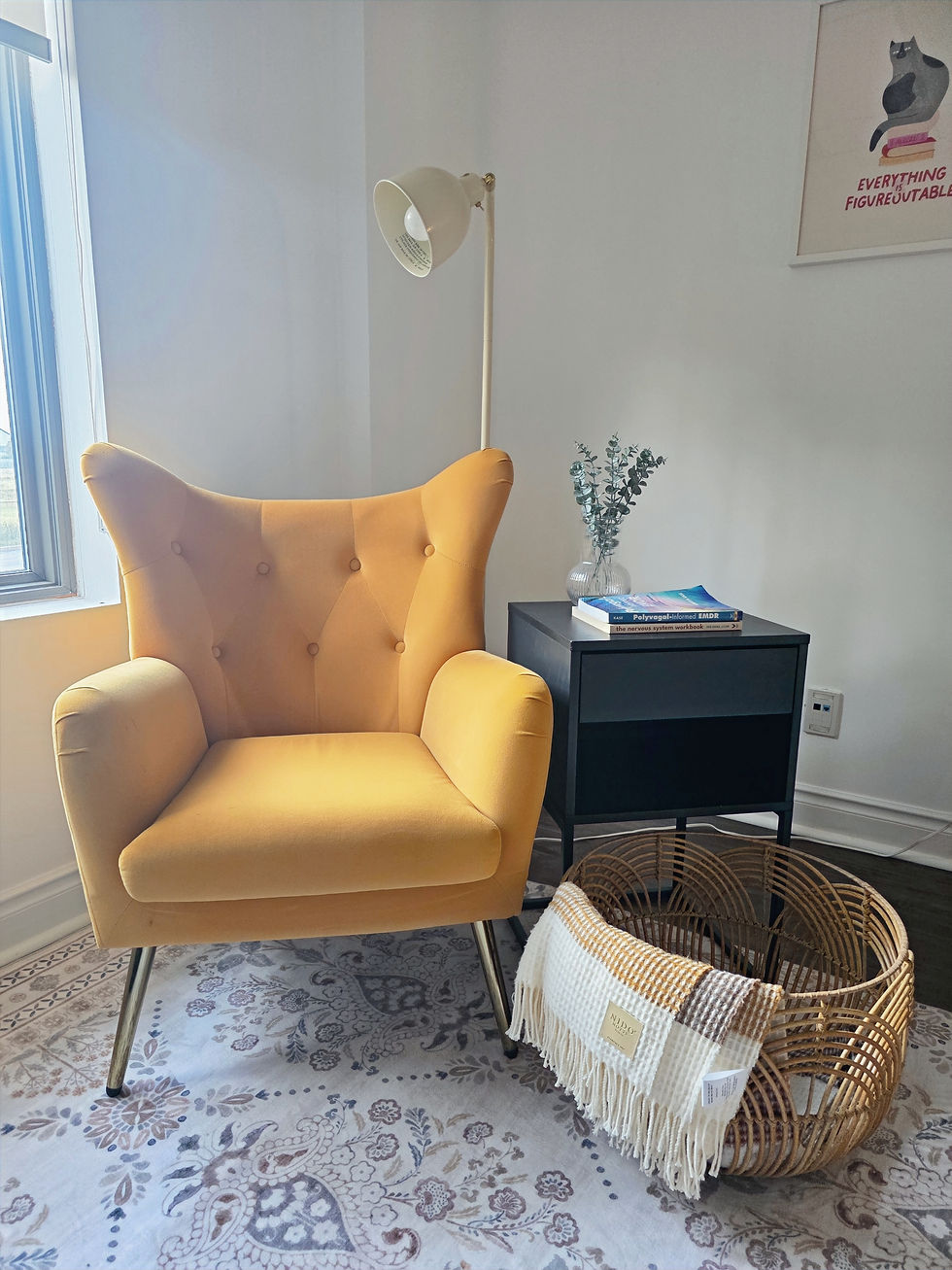 Therapy office seating area with couch and pillows, warm and inviting