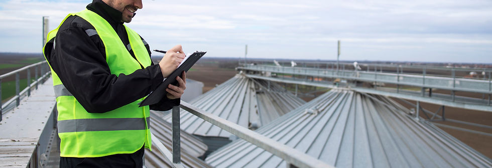 portrait-construction-worker-standing-rooftops-high-silos-storage-tanks-working-tablet-com