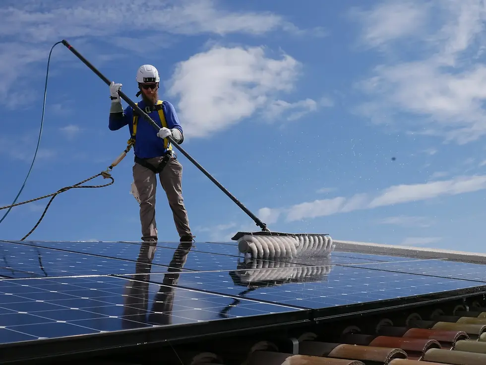 Nomadic Home Services technician cleaning solar panels on a North County San Diego roof