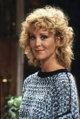 Image of Maggie Seaver from Growing Pains, smiling gently in a black and white knit sweater with perfectly feathered blonde hair.