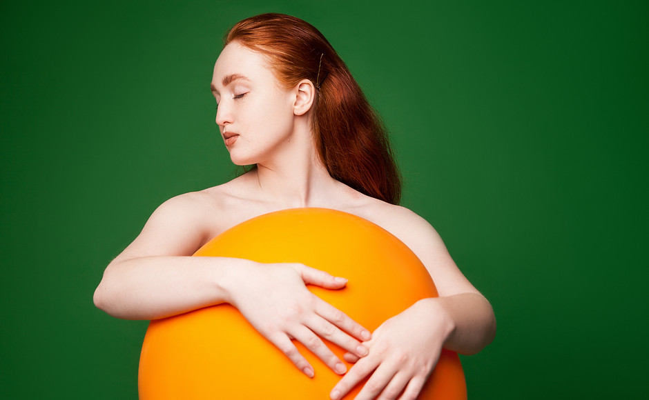 Girl Hugging Orange Ball