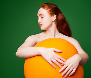 Girl Hugging Orange Ball