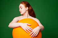 Girl Hugging Orange Ball