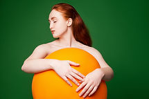 Girl Hugging Orange Ball