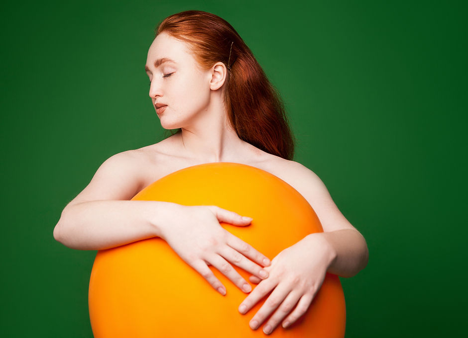 Girl Hugging Orange Ball