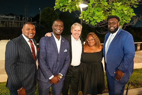 Lee Johnson standing in front of trees for a picture with some constituents at an outdoor event