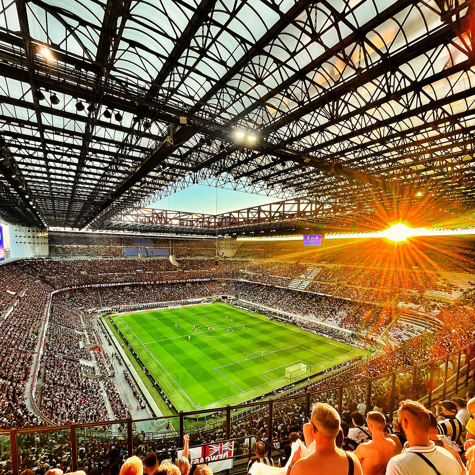 Sunset shining through the roof of the San Siro during a football match in Milan