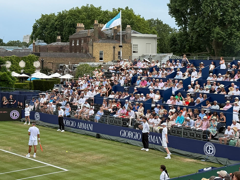 Spectators watching tennis on Centre Court at the Hurlingham Club.