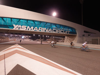 Cyclists passing under Yas Marina Circuit bridge during TrainYAS in Abu Dhabi