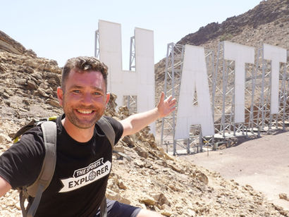 Hatta Sign hike in Hatta UAE with large HATTA letters in the Hajar Mountains