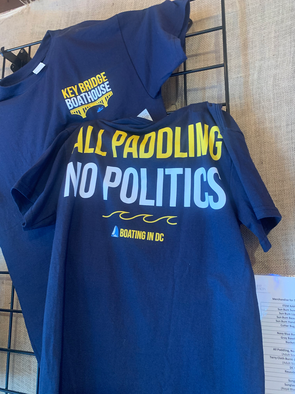 All Paddling No Politics T-shirt on display inside Key Bridge Boathouse gift shop.