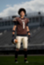 High school football player in brown HOLT jersey standing on field with ball – dramatic athlete portrait with stadium in background