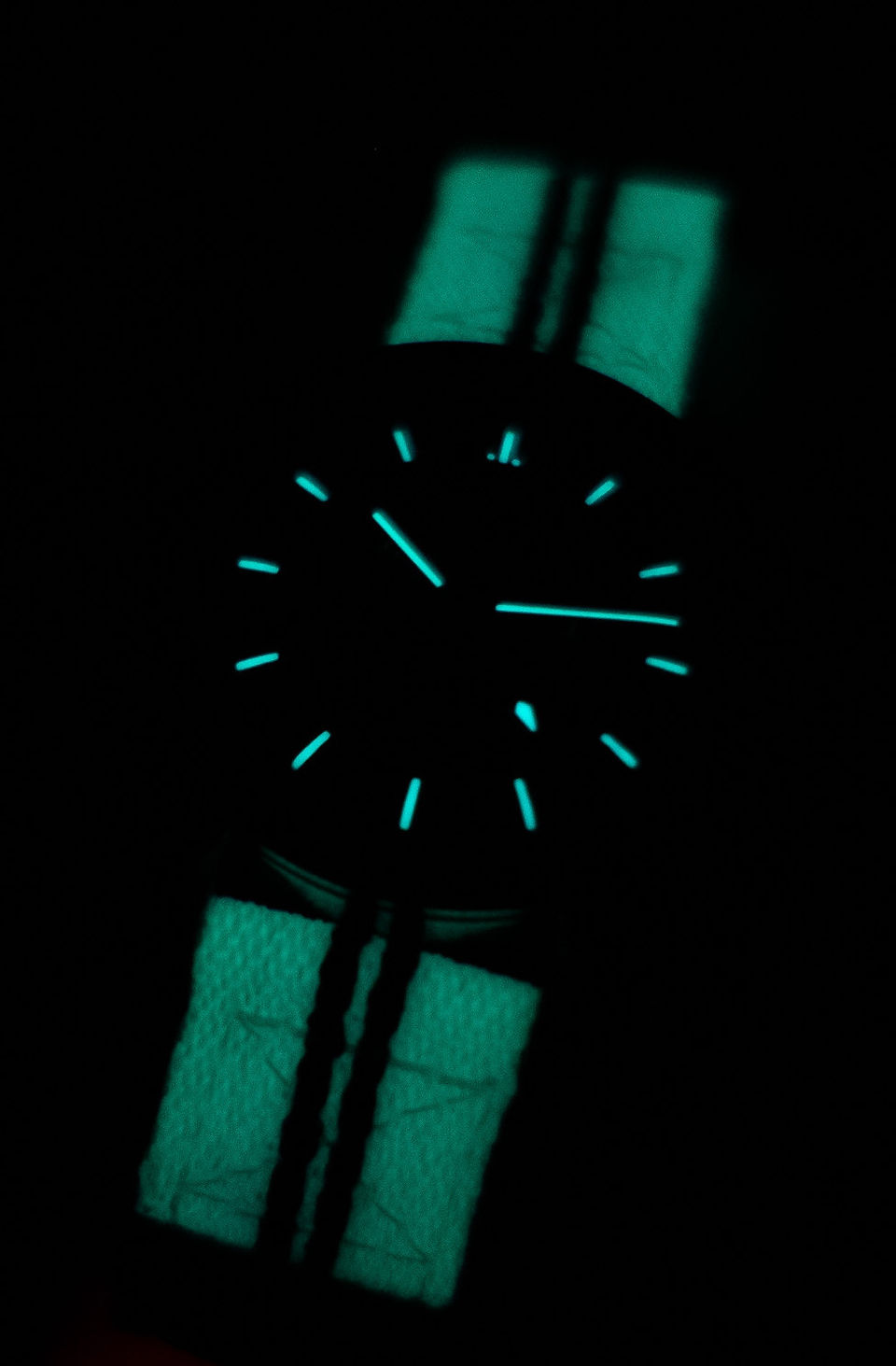 Zuludiver lunar fabric watch strap on an omega speedmaster in the dark, glowing