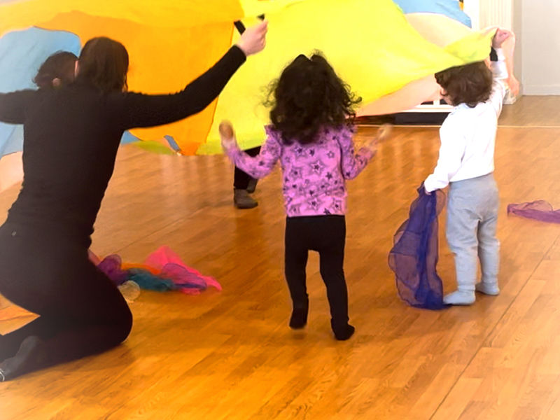 Littles class playing with a parachute