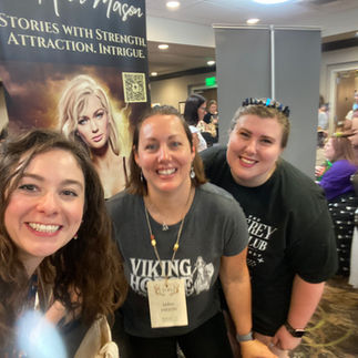 Three people smiling at the camera