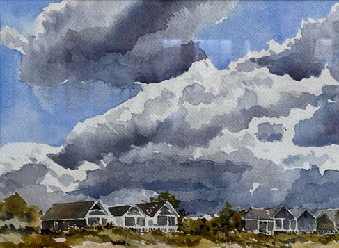 Watercolor painting by Artist Bob Harrington depicting a large blue sky with fluffy clouds floating over a grouping of small homes by the beachy grasslands. Art Active