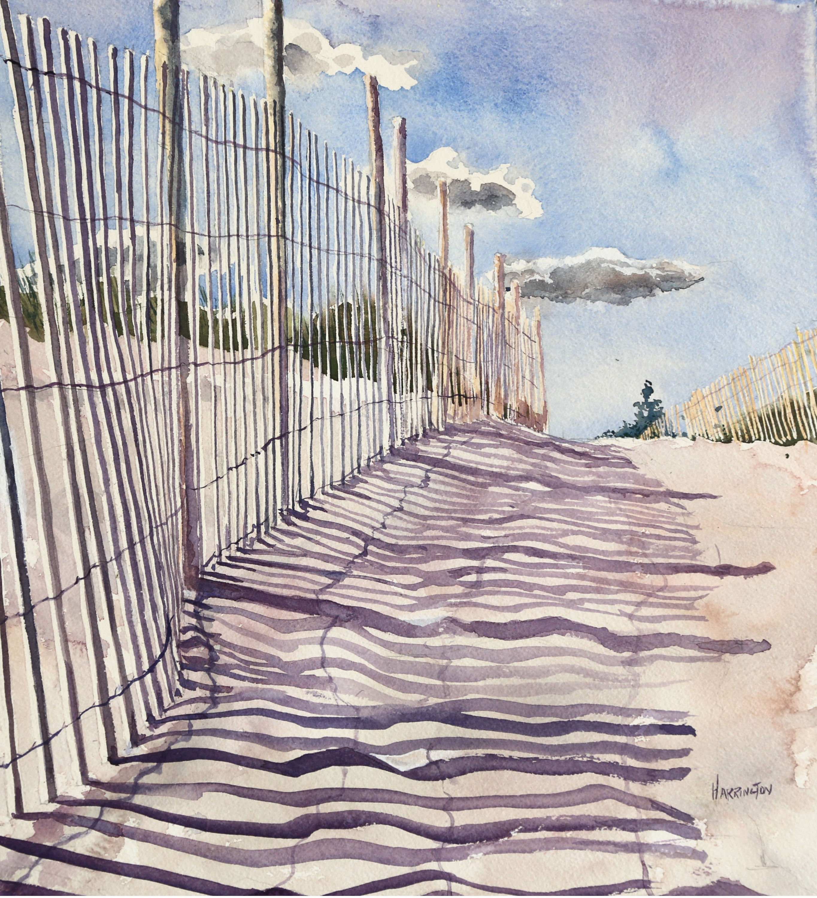 Fence shadows on sandy beach