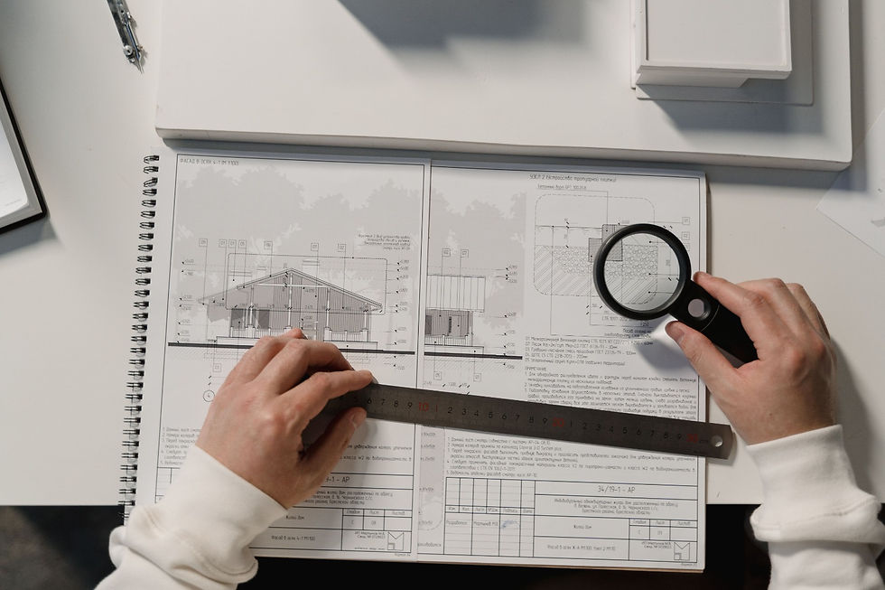 Architect using project coordination strategies on blueprints.
