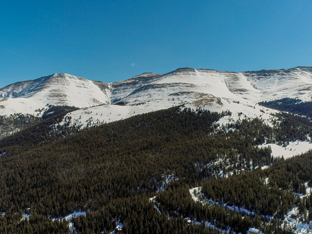 Aerial view of a shovel-ready mountain land lot in Summit County with surveyed boundaries