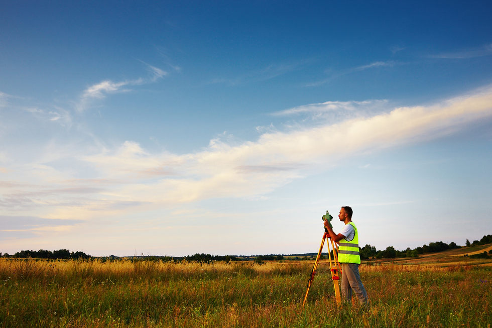Surveyor measuring land boundaries on a mountain property in Summit County