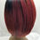 Thumbnail: Back view of Sarah on a mannequin. Red tone bob style.