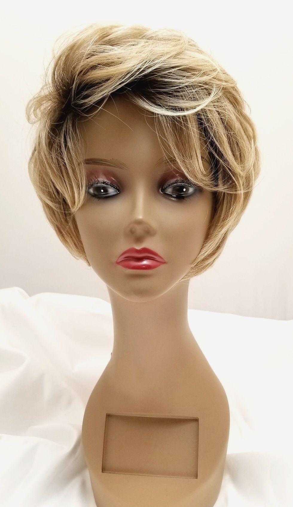 Thumbnail: Front View of Amy on a Mannequin: Short Cut with Loose Waves and Volume. Color in Blonde Tone.
