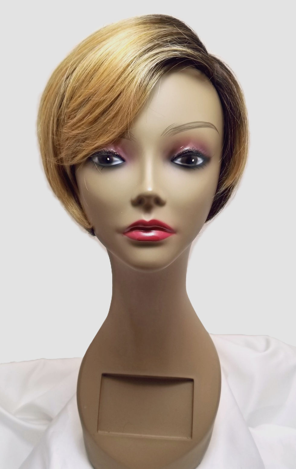 Wig style Vivi on a mannequin: Front view of blondish tone short bob style with sleepy bang.