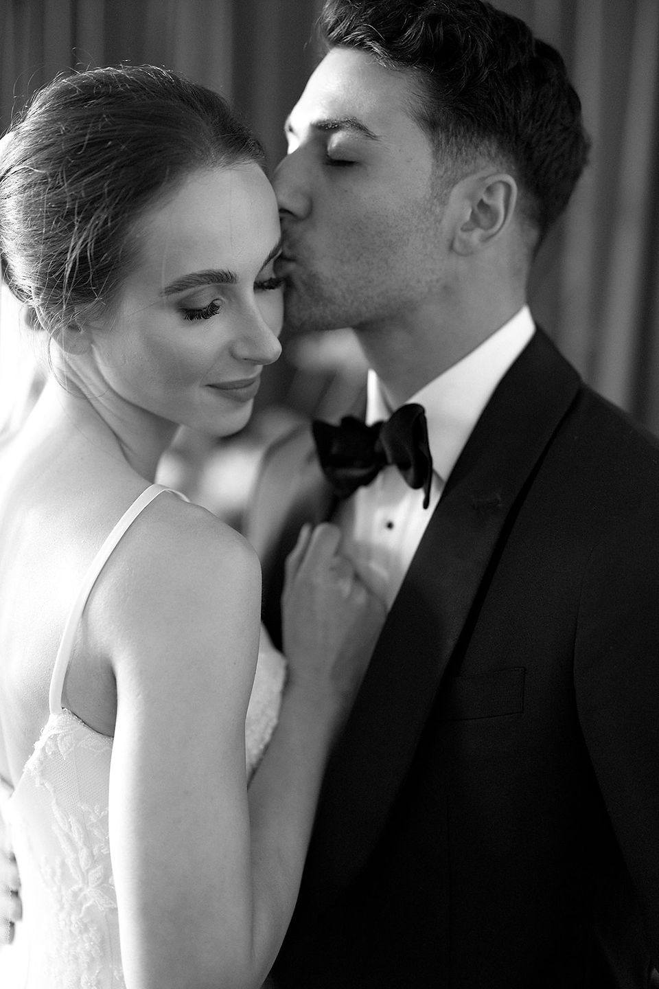 Black and white portrait of bride and groom capturing a quiet, intimate moment