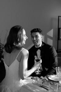 Bride and groom framed by wedding styling in a timeless black and white moment