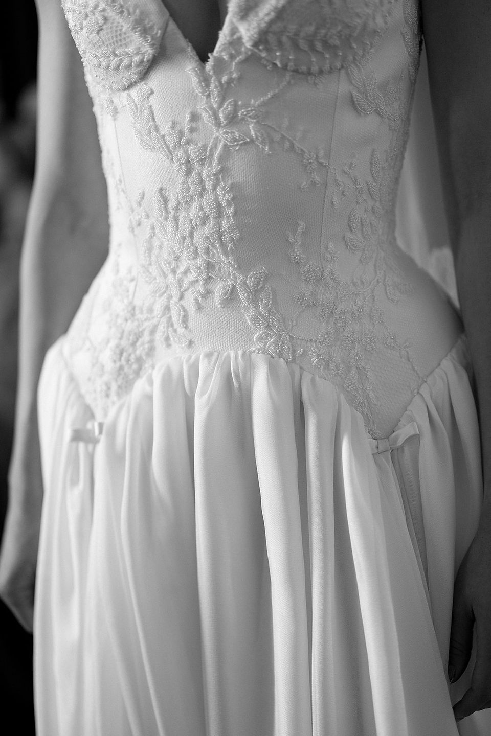 Black and white bridal portrait highlighting dress detail and soft movement
