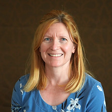 Author H.M.J. Bennetts poses in front of a brown background.