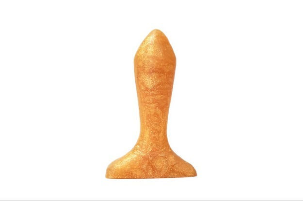 A gold colored butt plug