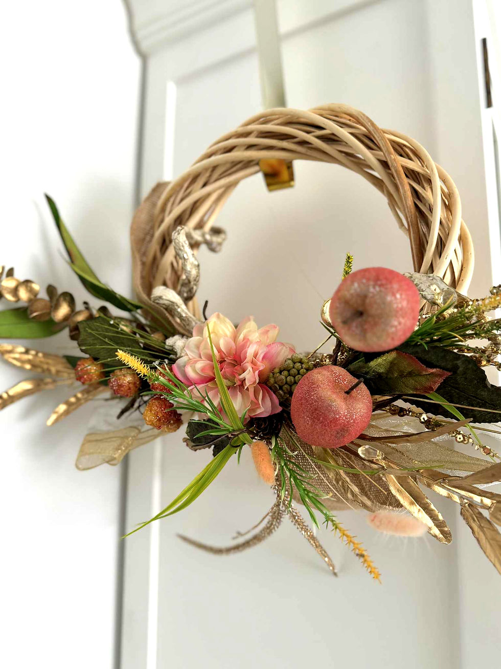 Handmade Christmas wreath with natural rattan base, pink dahlia, glitter apple baubles, gold leaves, Australian native green