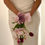 Thumbnail: Bride in minimalist ivory gown holding a petite cascading waterfall bouquet featuring soft pink orchids, deep burgundy tulips