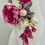 Thumbnail: Bride in white dress holding bridal bouquet with fuchsia pink peony, real touch tulip, silver suede, foxglove
