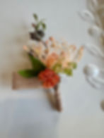 JW Weddings artificial floral buttonhole with tangerine buds, pincushion protea, brown burlap ribbon.