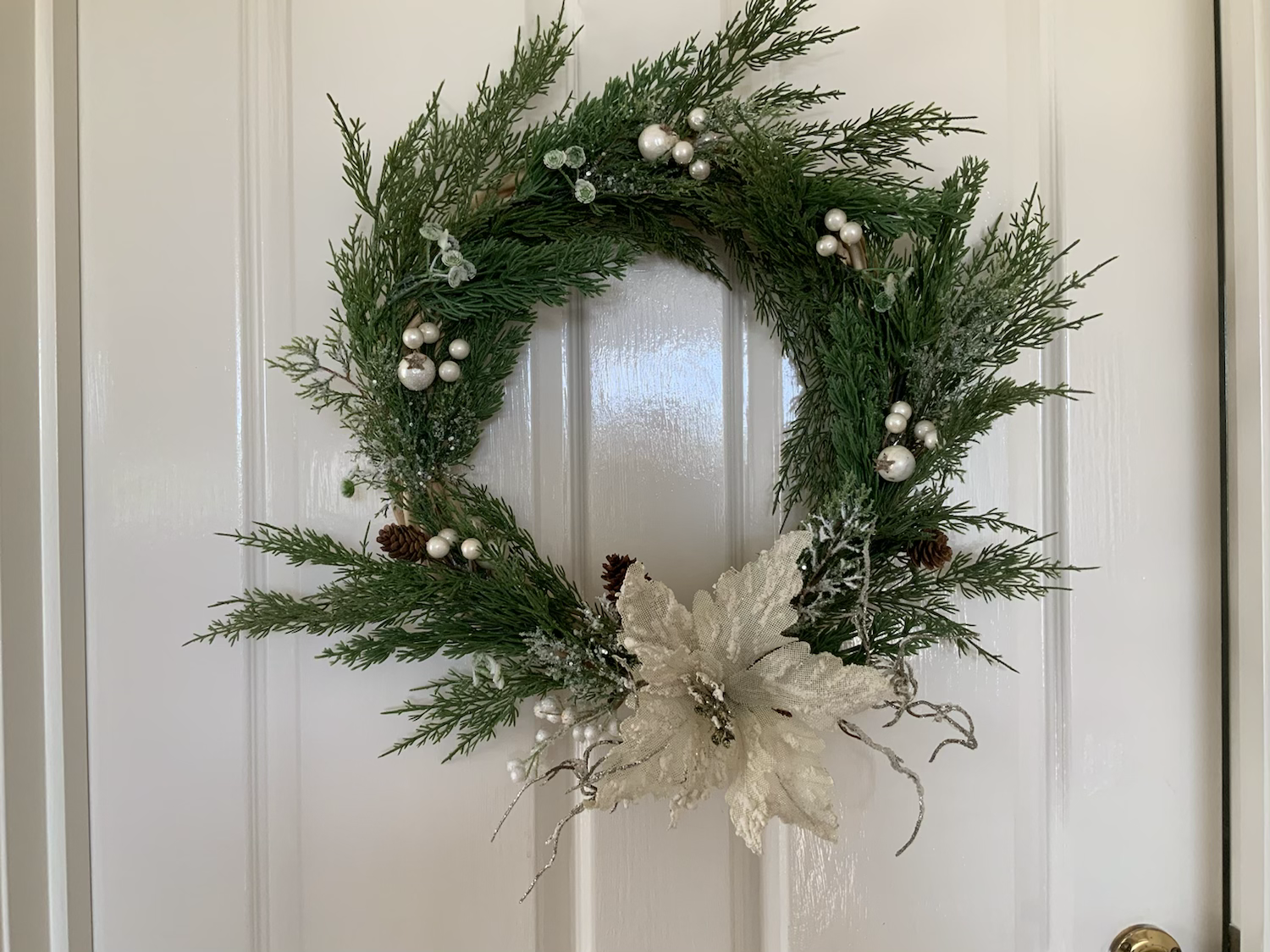Subtle demure ivory cream wreath with poinsettia and embellishments 