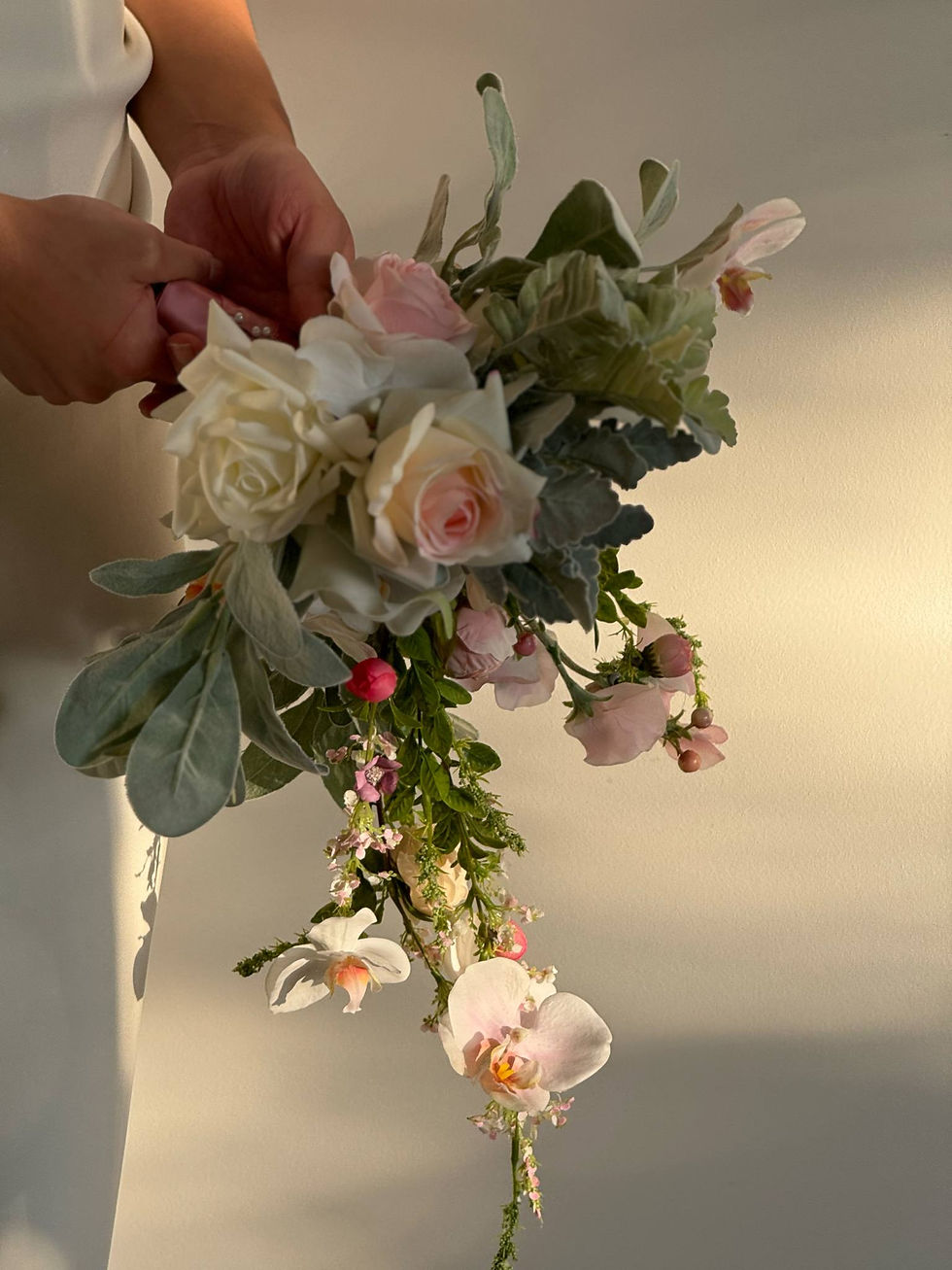 Thumbnail: Wedding bouquet, low section, showing trail with orchid, peonies and green foliage drenched in sunlight