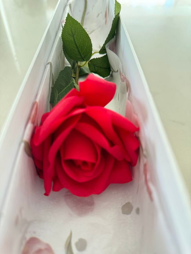 Thumbnail: closeup of real touch artificial long stem red rose - present for graduation ceremony