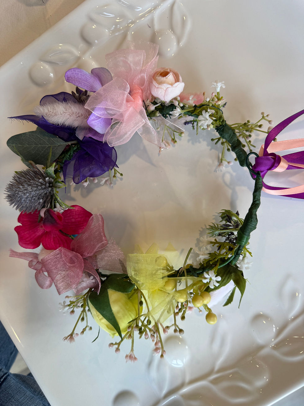 Top shot of JW Weddings floral headband with rose, onion flower, bunny tail, and organza ribbon